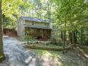 Attractive two-story home boasts a welcoming front porch and meticulously maintained flower beds at 613 Rock Springs Pass, Dallas, GA 30157