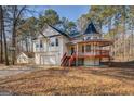 Two story house with unique turret, front porch, two-car garage, and storage shed at 787 N Ola Rd, Mcdonough, GA 30252