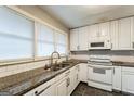 Functional kitchen showcasing white cabinets, granite countertops, and modern appliances at 3485 Maplehurst Dr, Decatur, GA 30032