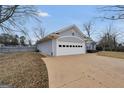 Home exterior with a large garage and wide driveway for easy access and ample parking at 11531 E Lovejoy Rd, Hampton, GA 30228