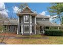 Stunning exterior view of a two-story home showcasing a bay window and inviting covered porch at 1954 Saybrook Ct, Jonesboro, GA 30236