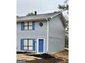 Exterior view of a two-story home featuring light-blue painted brick and complementing blue shutters at 1309 Lakeview Nw Dr, Conyers, GA 30012