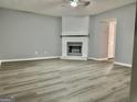 The living room features modern flooring, fresh paint, and a classic white-tile fireplace at 1309 Lakeview Nw Dr, Conyers, GA 30012