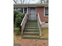 Close up of the wooden steps leading to the front door with protective metal security door at 392 Carey Se Dr, Atlanta, GA 30315