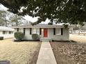 Well-maintained single-story home with brick facade, walkway, and red door at 1779 Rosewood Rd, Decatur, GA 30032