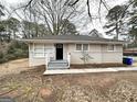Single-story home featuring a tidy front yard, classic brick accents, and a welcoming entryway at 2004 Shamrock Dr, Decatur, GA 30032