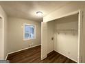 Bedroom with wood floors, a window, and a closet with sliding doors at 3696 Aldea Dr, Decatur, GA 30032