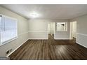 Spacious living room with wood-look floors, neutral paint, and bright window at 3711 Tulip Dr, Decatur, GA 30032