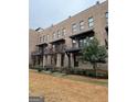 Brick townhome with stylish balconies, offering a blend of classic and modern design elements at 1028 Robert Smalls Way, Atlanta, GA 30318