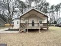 Charming home featuring a front porch with wooden beams and stairs at 1158 Edgefield Sw Dr, Atlanta, GA 30310