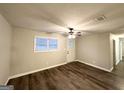 Inviting living room with wood-look flooring, neutral walls, and bright natural light at 3507 Sage Dr, Lithia Springs, GA 30122