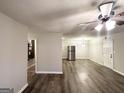 Spacious living room featuring wood-look flooring, neutral walls, and a modern ceiling fan at 3507 Sage Dr, Lithia Springs, GA 30122