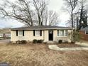 A cozy one-story home with a paved walkway and minimal landscaping against a winter backdrop at 360 Belgarde Pl, Atlanta, GA 30354