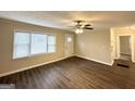 Inviting living room with sleek dark hardwood floors, a ceiling fan, and neutral paint at 2174 Doris Dr, Decatur, GA 30034