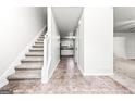 Bright foyer with staircase and tile flooring, leading to the kitchen and living area at 2916 Ward Lake Way, Ellenwood, GA 30294