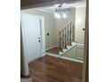 Inviting foyer with hardwood floors, staircase, and a modern light fixture upon entry at 10020 Crystal Ter, Jonesboro, GA 30238