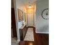 Hallway featuring wood floors, overhead lighting, framed art and a long thin accent table at 870 Nw Mayson Turner Nw Rd # 1227, Atlanta, GA 30314