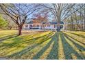 A charming single-Gathering home with a well-manicured front yard and mature shade trees at 125 Keyland Dr, Fayetteville, GA 30215