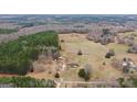 Overhead view featuring the property with land, home, and workshop with a backdrop of a sprawling forest at 62 Honey Ln, Mcdonough, GA 30252