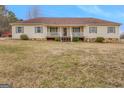 Charming single-story home featuring a cozy front porch, neutral siding, and meticulously kept lawn at 62 Honey Ln, Mcdonough, GA 30252