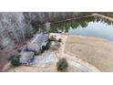 Birds-eye view showcasing the home's layout, pond, and outdoor space at 1187 Attaway Road, Roopville, GA 30170