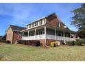 Exterior view of the home showing the large porch and well-maintained lawn at 135 Oakpark Ter, Mcdonough, GA 30253