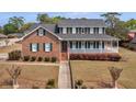 Beautiful two-story brick home with a welcoming front porch at 135 Oakpark Ter, Mcdonough, GA 30253