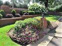 Landscaped garden with vibrant flowers and lush greenery at 135 Oakpark Ter, Mcdonough, GA 30253