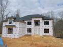 New construction home showing weather protection, black windows, and dark roof at 2015 Fontainbleau Dr, Conyers, GA 30094