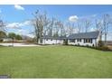 Expansive home with a basketball court beside the meticulously kept lawn at 757 Fischer Rd, Sharpsburg, GA 30277
