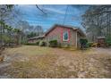 Brick exterior, red shutters, nice lawn, and a play set, perfect for Gathering enjoyment at 308 Tulipwood Sw Cir, Conyers, GA 30094