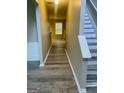 Bright hallway featuring neutral walls, hardwood floors and stairs leading up to the second floor at 801 Winbrook Dr, Mcdonough, GA 30253