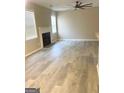 Bright living room features a fireplace, neutral walls, and gray wood-look flooring at 801 Winbrook Dr, Mcdonough, GA 30253