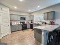 Modern kitchen featuring granite countertops, sleek gray cabinetry, and updated appliances at 3092 Cedar Crest Way, Decatur, GA 30034
