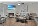 Cozy living room featuring a fireplace, ceiling fan, and comfortable leather seating at 3092 Cedar Crest Way, Decatur, GA 30034