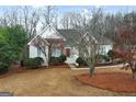 Traditional home featuring a stone facade and manicured landscaping offering an inviting curb appeal at 9135 Woodhaven Way, Mcdonough, GA 30253