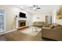 A cozy living room features hardwood floors, a brick fireplace, and neutral-toned furniture at 3973 Laurel Bend Dr, Snellville, GA 30039