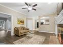 Living room with a ceiling fan, hardwood floors, and an open view to the kitchen at 3973 Laurel Bend Dr, Snellville, GA 30039