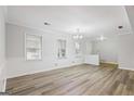 Bright, open-concept living room features hardwood floors and modern fixtures at 334 Nancy Sw Ct, Lilburn, GA 30047
