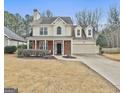 Charming two-story home with a brick front porch and an attached two-car garage at 208 Clifton Ln, Peachtree City, GA 30269