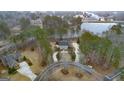 An aerial view of a stately home with a circular driveway and a scenic lake nearby at 256 Allie Dr, Mcdonough, GA 30252