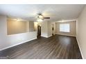 Bright living room with sleek dark floors, open floor plan, and view into kitchen at 5743 Rock Rd, Union City, GA 30291