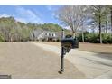 A long driveway leads to this picturesque home with dormer windows and a well-manicured lawn at 115 Foxford Run, Tyrone, GA 30290