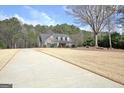 A long driveway leads to this charming home with dormer windows and a meticulously kept lawn at 115 Foxford Run, Tyrone, GA 30290