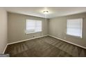 Bedroom features neutral paint, carpeted floors, and bright, natural light at 4734 Campbellton Sw Rd, Atlanta, GA 30331