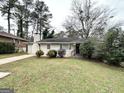Charming ranch-style home featuring a well-manicured lawn and a classic brick exterior at 2030 Mark Trl, Decatur, GA 30032