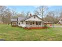 Quaint single-story home with a covered carport and metal roof, surrounded by a green lawn at 110 Bevis Cir, Bowdon, GA 30108