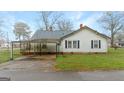 Traditional single-story home with a metal roof and a convenient carport for covered parking at 110 Bevis Cir, Bowdon, GA 30108