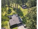 Aerial view of the house and barn with lots of trees on a sprawling green lawn at 225 Banks Rd, Fayetteville, GA 30214