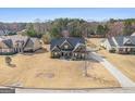 An aerial view showcasing the neighborhood and the home's position on a sprawling, well-maintained lawn at 37 Water Oak Dr, Sharpsburg, GA 30277